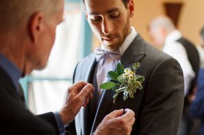 Pinnin the Boutonniere on the Groom