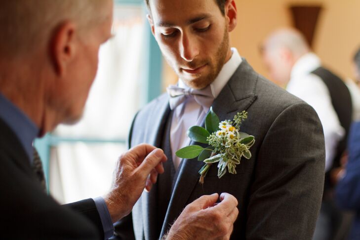 Pinnin the Boutonniere on the Groom