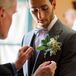 Pinnin the Boutonniere on the Groom