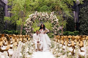 Bride and Groom in All-White Outfits in Fairytale Ceremony Space