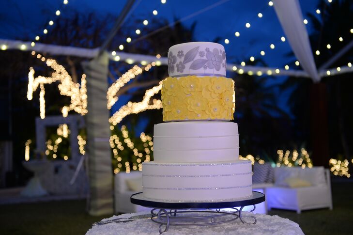 The wedding cake was a white, yellow and silver four-tiered confection that was served after the four-course reception meal.