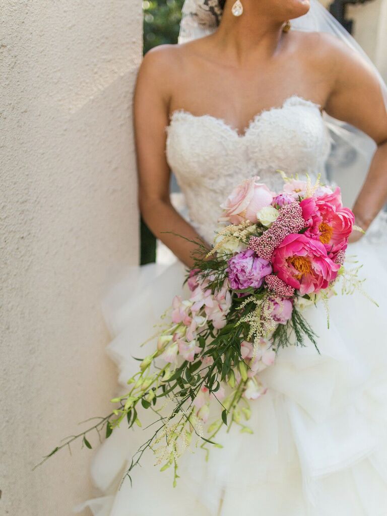 bright pink and purple cascade bouquet with peonies and orchids