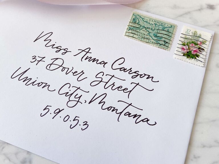 White envelope with fancy black calligraphy name and address