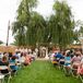 “We have this beautiful willow tree that we had as our backdrop and a couple of friends along with Eric surprised me with a handmade,rncustom and beautifully framing arch,” Sharon says. “The setting turned out so beautiful, cozy and intimate and mainly because our family and friends were involved from the very beginning.”