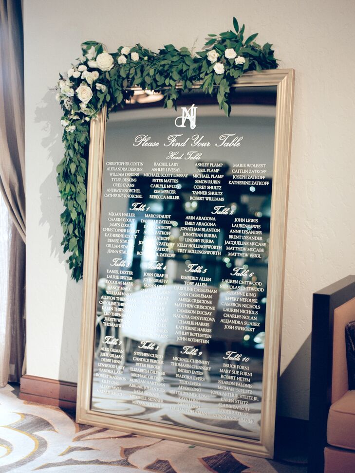 A large mirror with an elegant vinyl applique helped guests find their tables. “It was another opportunity to showcase a beautiful garland,” Ashley says. It was also in one large piece, eliminating the need to keep track of individual escort cards.