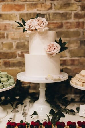 Tiered Wedding Cake with Flowers and a White Stand