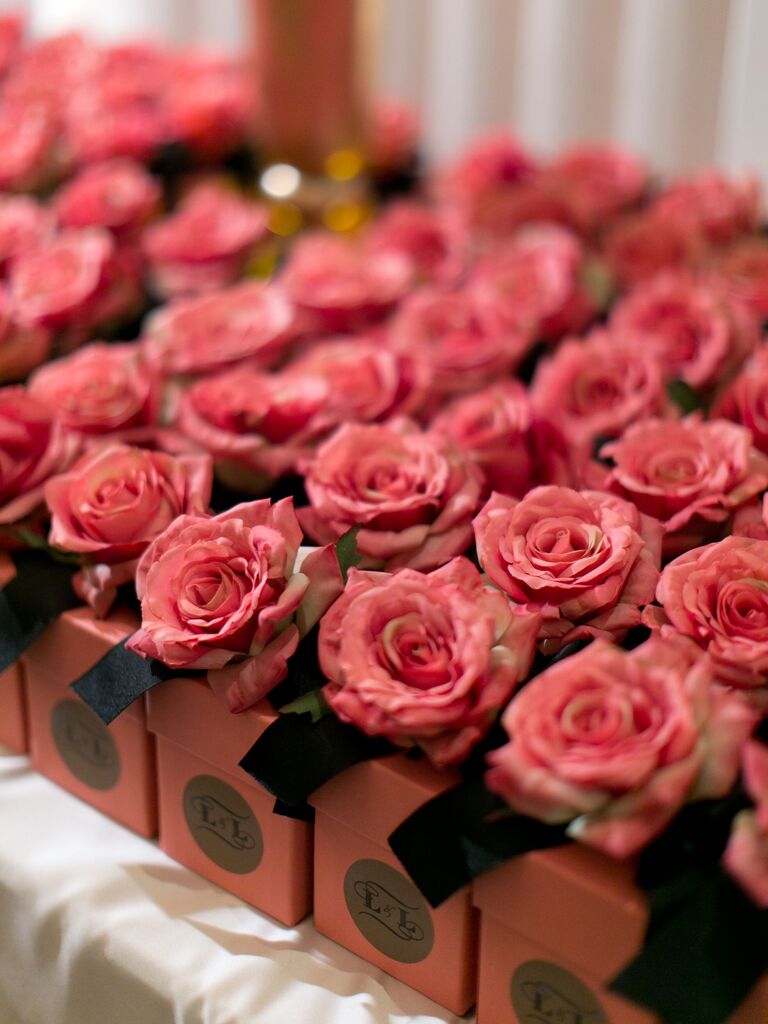 engagement party favor boxes with a pink rose on top of each box