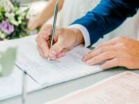 man signing marriage license