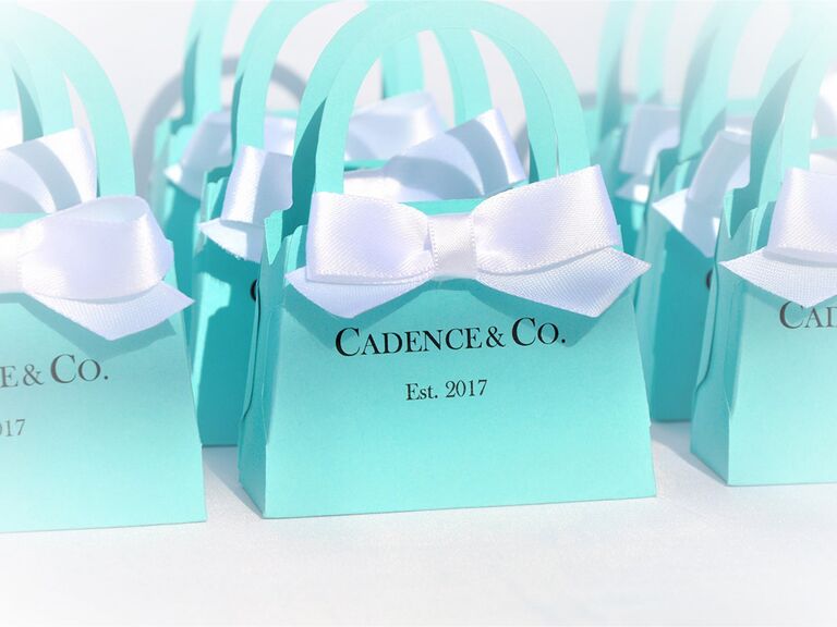 Tiffany blue purse-shaped goodie bags with white bow and 'Name & Co.' in blue type