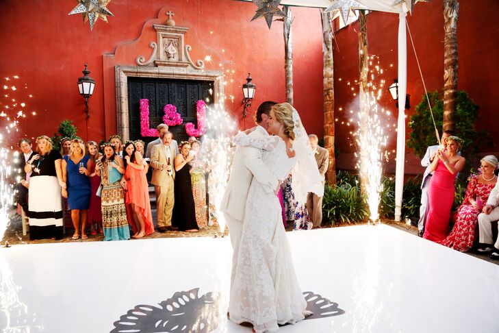 Louisa and Joseph shared their first dance on a white dance floor surrounded by fireworks. It was romantic and striking—just what they wanted.