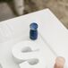Instead of a traditional Chinese tea ceremony, Priscilla and Daniel opted for a custom unity paint ceremony during their wedding. Together, they poured rose gold and navy paint over a white S, representing his last initial. (The tea ceremony came later at their second reception, in Hong Kong.)