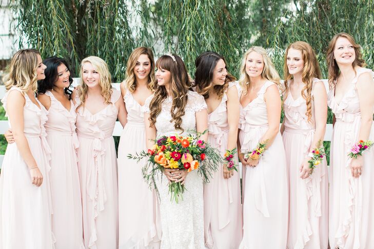 Courtney found a universally flattering bridesmaid gown that suited all eight of her bridesmaids—even one who was pregnant! They all wore the Polly Dress in blush by Joanna August from BHLDN.