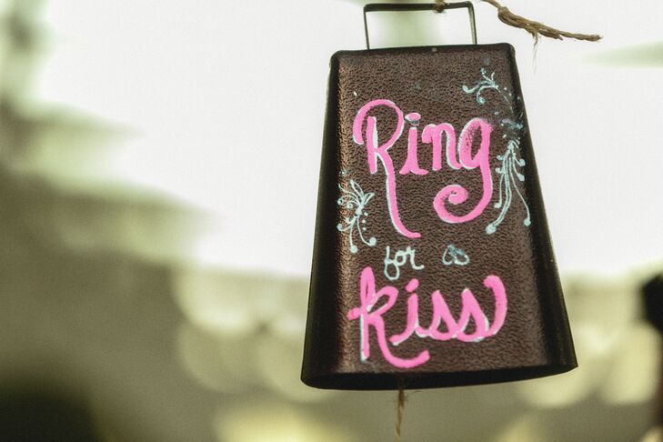 Francesca and Ricky created a hand-painted cowbell that guests and wedding party members could ring for the couple to kiss. It said, "Ring for a kiss!"