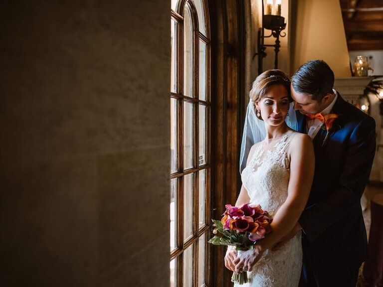 Bride wears her hair in an elegant updo on her wedding day. 