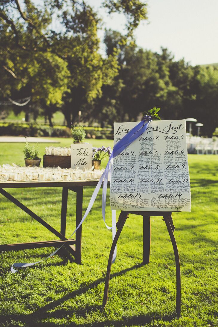 Guests found their seats by finding their name on an elegantly calligraphed seating chart displayed on a vintage easel.