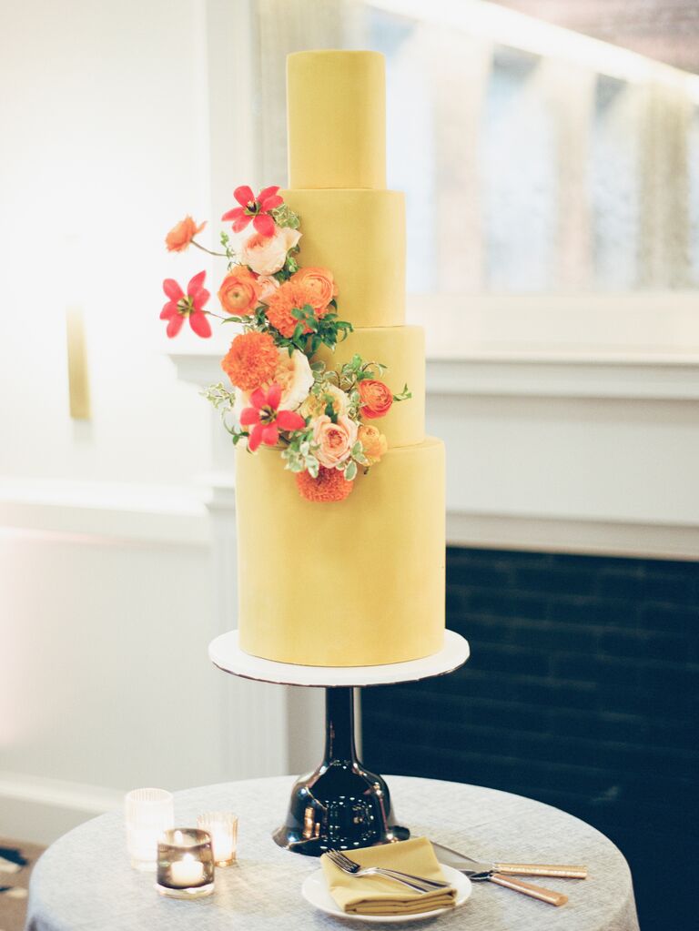 modern yellow fondant wedding cake with orange flowers