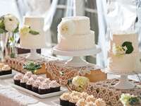 Tiered wedding cakes with flowers and cupcakes