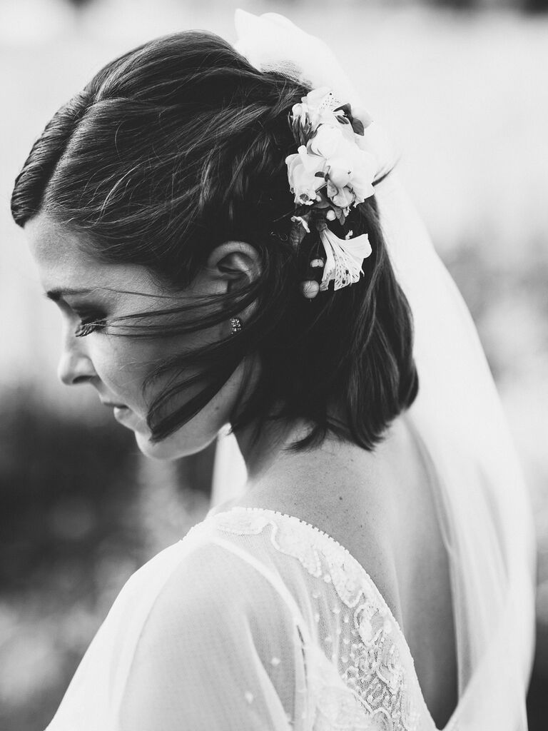 half up wedding hairstyle for short hair with flower and veil