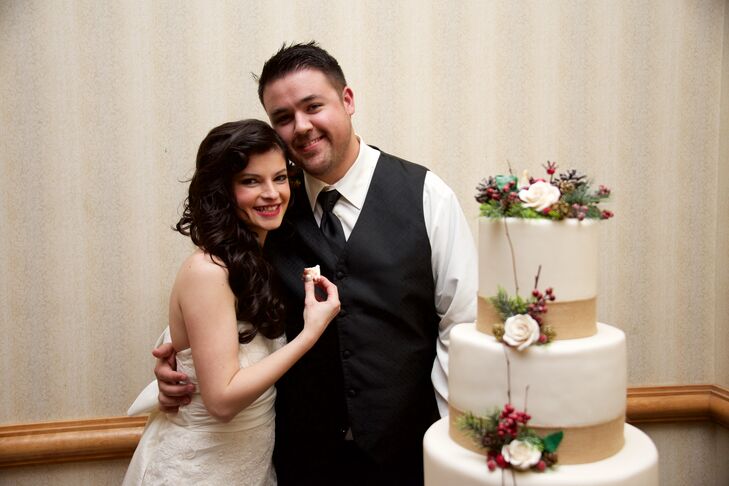 Camelia and Simon had a wintery wedding cake decorated with white roses, red berries and pinecones.