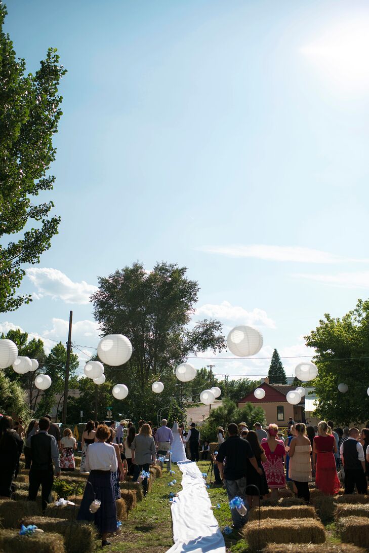 Lacey and Sara kept the decor simple with white paper lanterns and hay bales for their casual outdoor wedding.