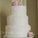 Gorgeous sugar peonies with chartreuse leaves transformed the white-frosted cake with a Swiss dot design into an elegant centerpiece.