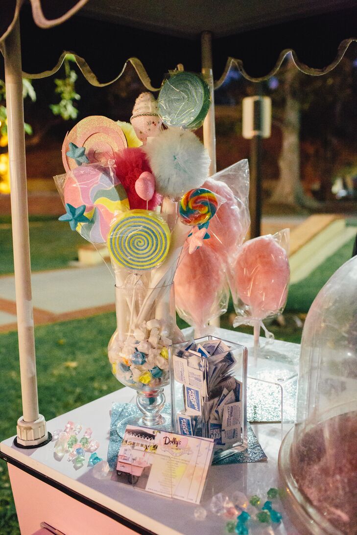 “Dolly's Cotton Candy helped us create our centerpieces. We filled long square vases with multicolored sprinkles and stuffed freshly made cotton candy on a stick in the center,” says the couple.