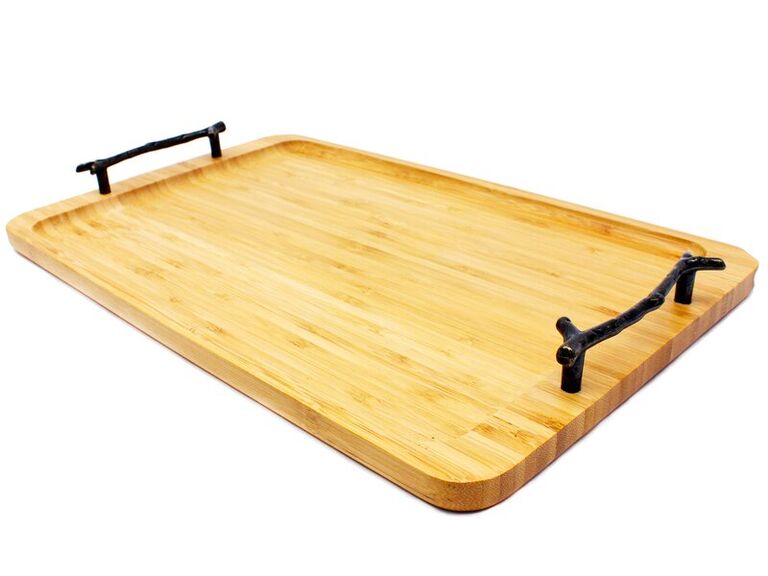 A wooden serving tray with iron branch-style handles for modern six year anniversary gift idea