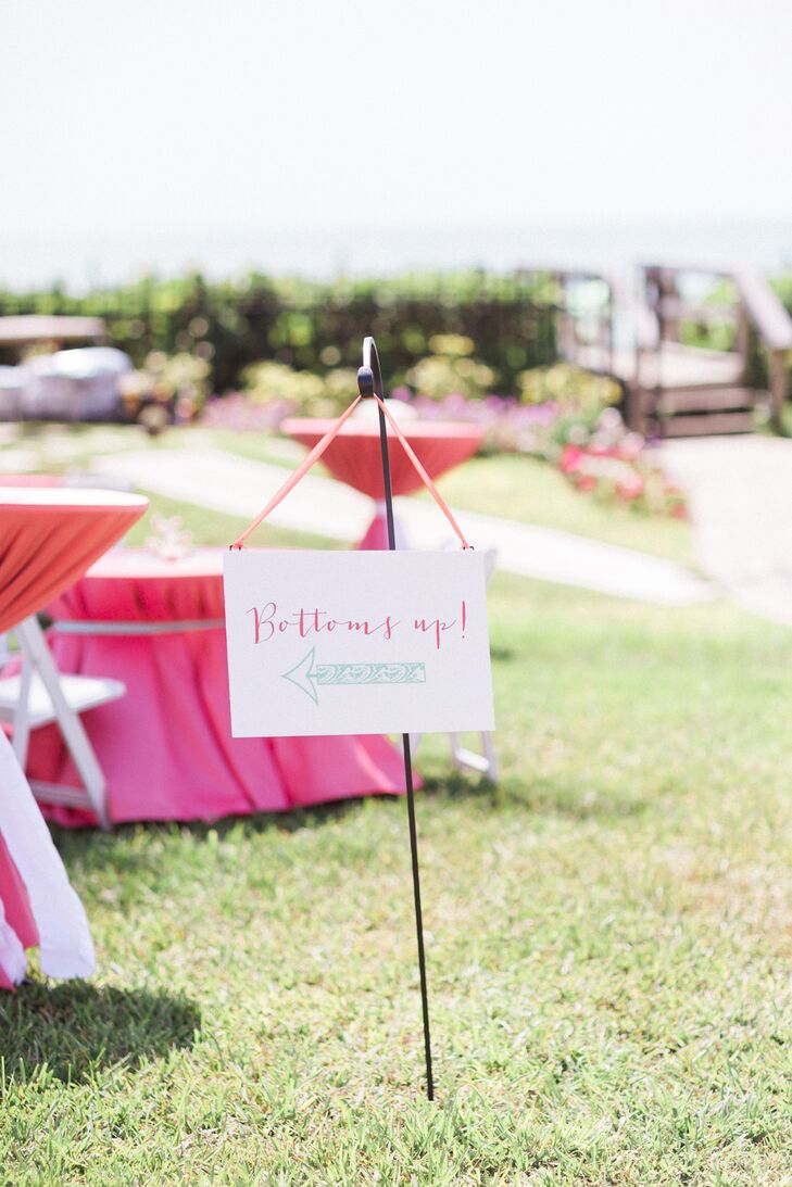 Guests enjoyed cocktail hour in two locations. A sign encouraged them to mingle outside, where they could take in the waterfront view. Anyone who wanted to stay out of the sun could go inside, where modern white lounge furniture added to the relaxing atmosphere.