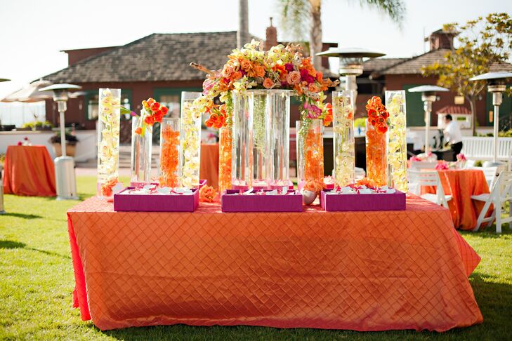 A bright display of submerged orchids in tall vases served as the focal point of the escort card table.