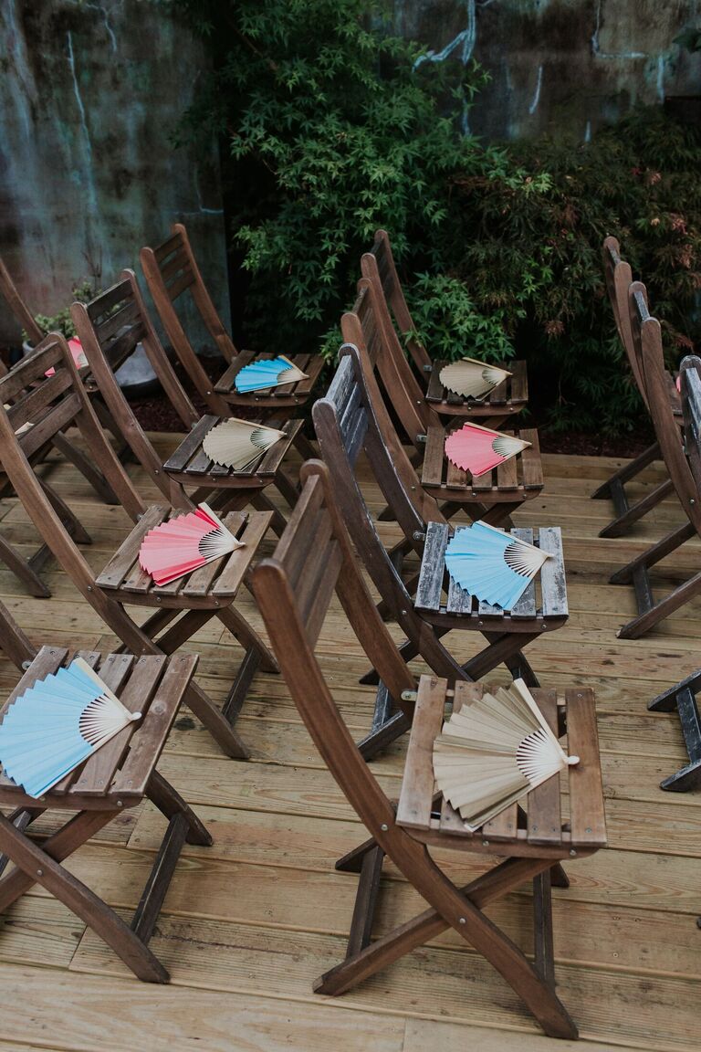 Fans on folding chairs at wedding ceremony