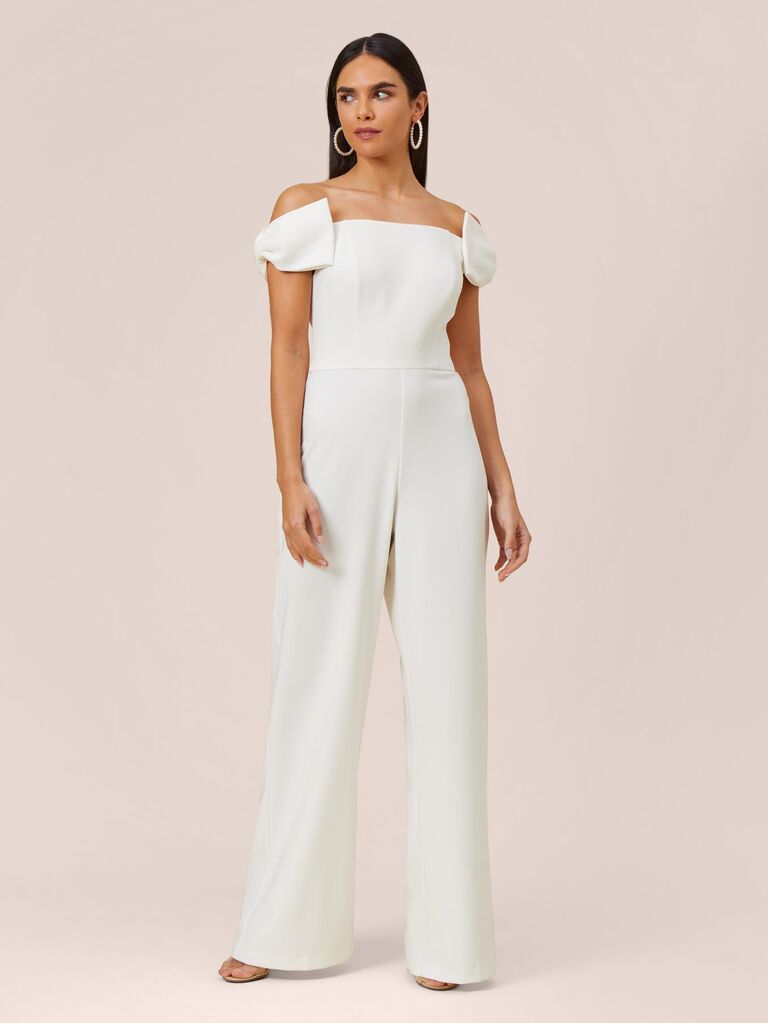 Model wears an elegant white jumpsuit. 