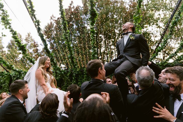 Couple in Chairs During Jewish Hora Dance