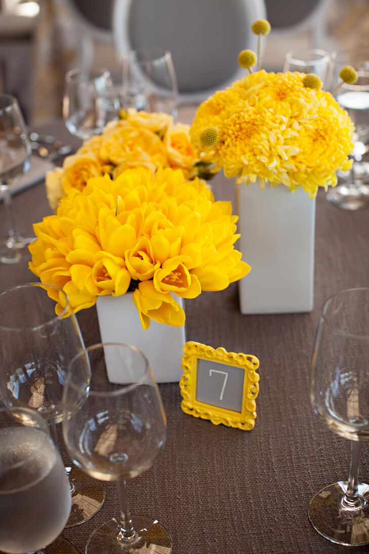 Arrangements of bright-yellow mums, tulips and craspedia topped some tables.