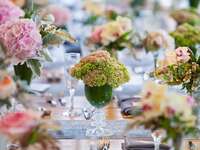 Wedding reception floral arrangements in colored glassware