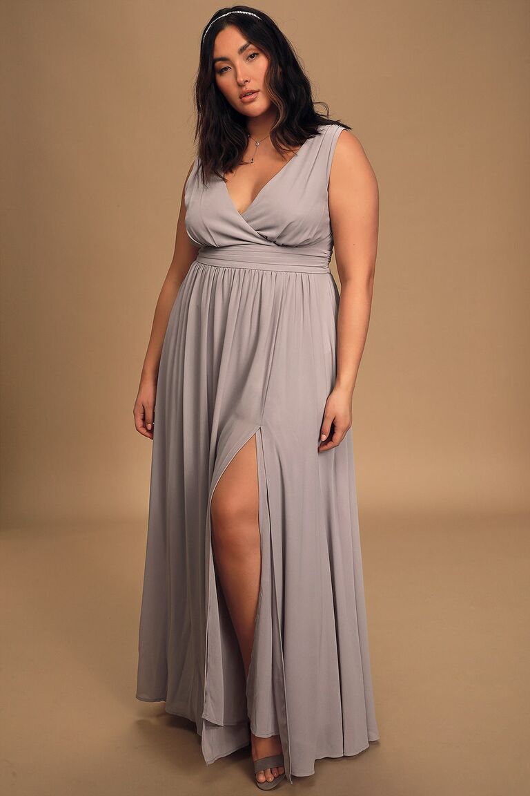 Model wears a beautiful draping dress with a v-shaped neckline. 