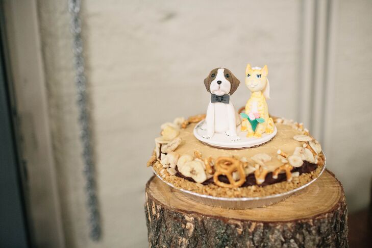 "I was lucky enough to have so many talented friends who contributed to our wedding in amazing ways," the bride says. "A friend from college has a cake-making business and made us a Saint Bernard and orange cat cake topper that paid homage to our cat, Chuck. They sat on top of a Fat Elvis pie and it was so 'us'."