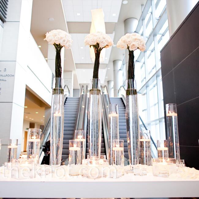 A towering display of roses and floating candles directed guests to the ballroom for cocktail hour.