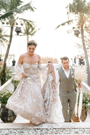 Bride in Gold Crown, Off-the-Shoulder Dress and Groom in Light Gray Suit Holding Bouquet in Recessional