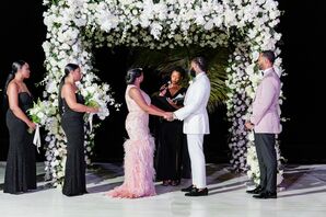 Wedding Ceremony With White Floral Arch