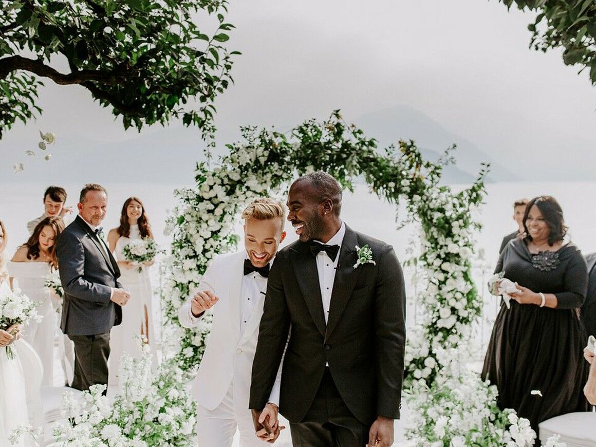 two grooms walking down the aisle