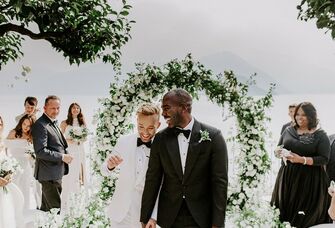 two grooms walking down the aisle
