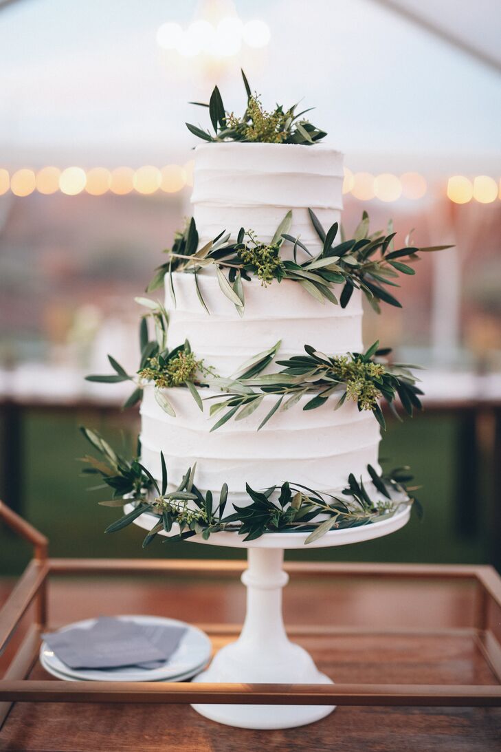 A simple olive branch on the wedding cake adds a touch of cost-effective greenery.