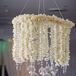 White orchid and crystal chandeliers hung from the ceiling and added a soft glow courtesy of the globe votives that hung below.