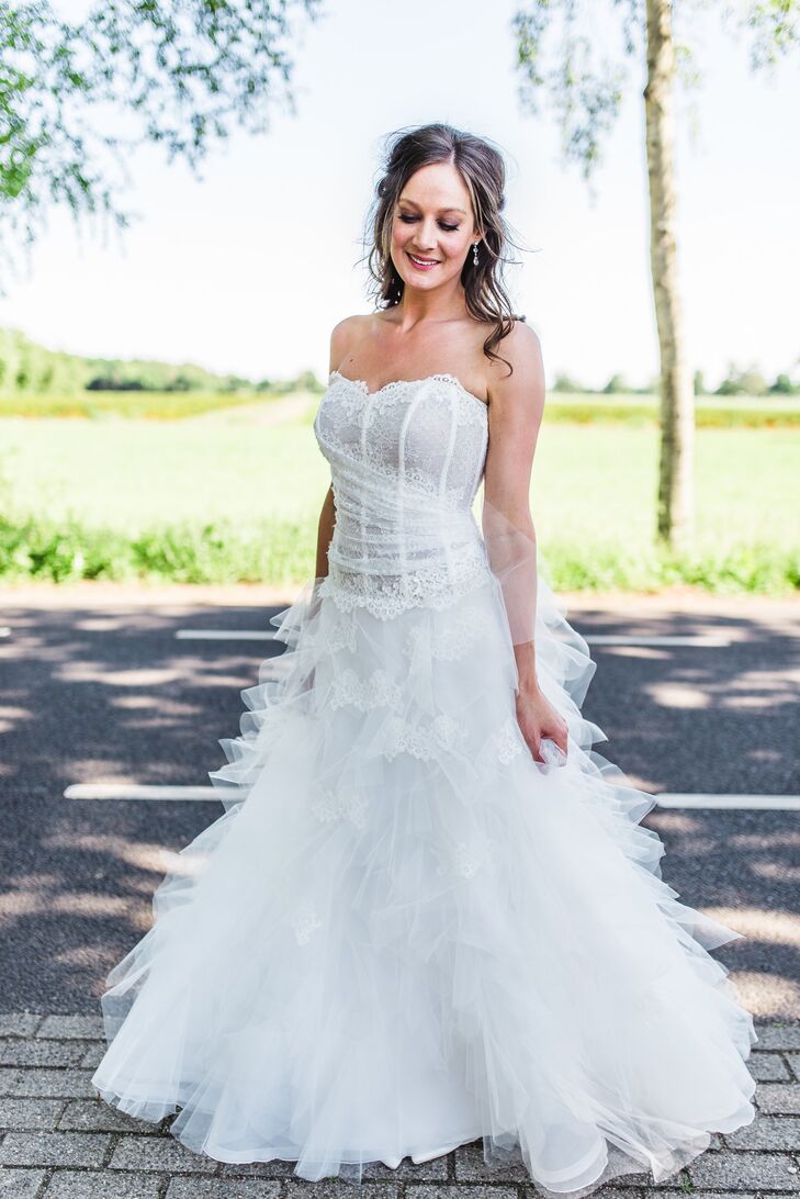Amanda wore a strapless ball gown with a lace bodice and a ruffled skirt with lace details. "It was different from what I envisioned myself wearing, but when I tried it on I fell in love," she says. She wanted to look natural, so she styled her hair down and wore light makeup.