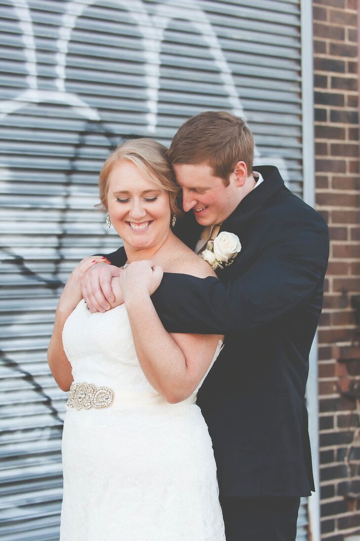 The bride opted for a sideswept updo and elegant drop earrings to go with her white lace Eugenia Couture wedding dress.