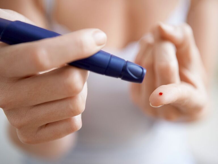 person performing blood test on herself