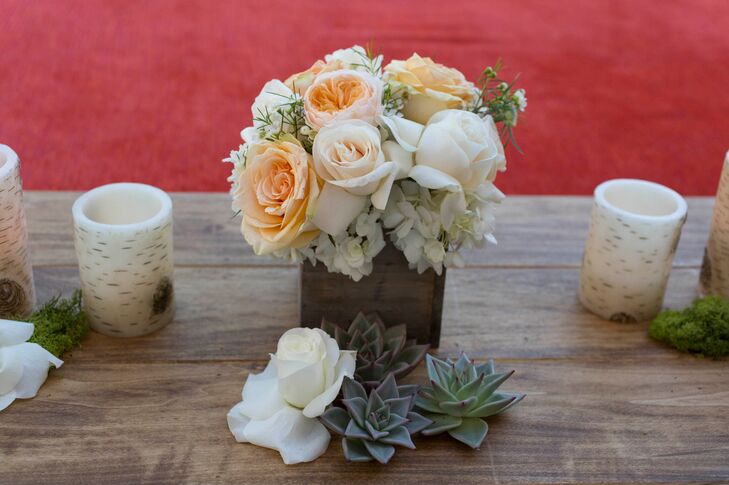 Natural-colored roses, including peach and ivory, were placed in wooden planter boxes on all the tables. Along with succulents, they matched the desert surroundings.