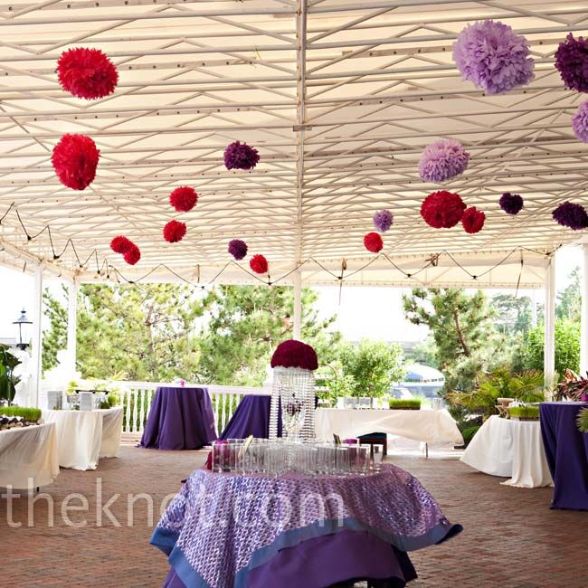 Purple and red paper poms hanging from the rafters and sequin linens set the tone for the evening’s party.