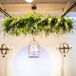 During the ceremony, Chelsea and Chris stood under a natural chandelier made of leaves with ivory bloom accents. The decoration went with the many other natural-looking arrangements, from the bridal bouquet to the dining table centerpieces.