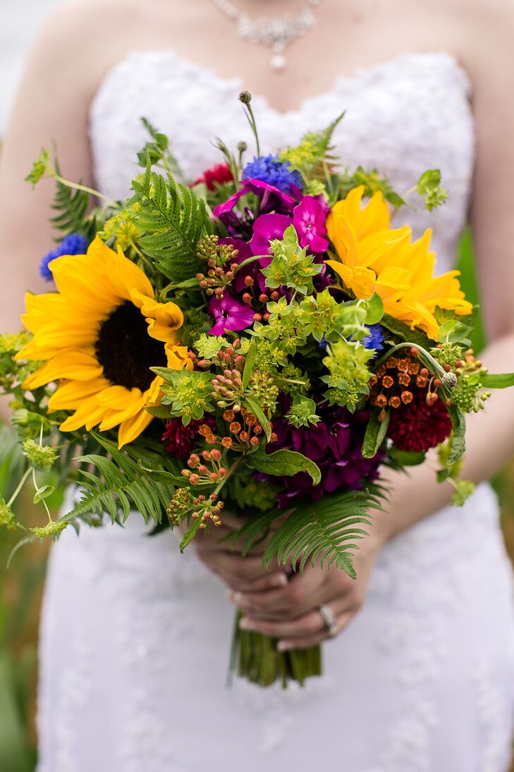 Justine held a lush bouquet of wildflower accents with greenery on her wedding day.